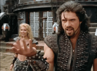 Man And Woman Standing In Front Of Building GIF