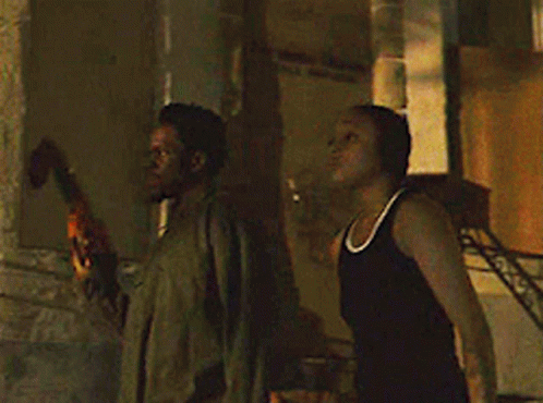Man And Woman Standing In Front Of Building GIF