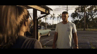 Man And Woman Standing In Front Of Building GIF