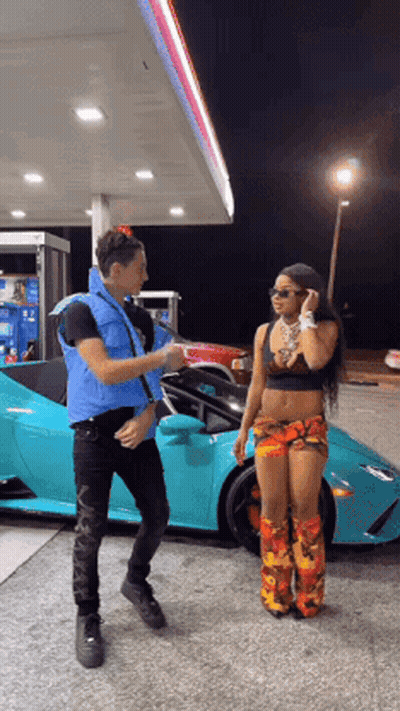 Man And Woman Standing In Front Of Car At Gas Station GIF