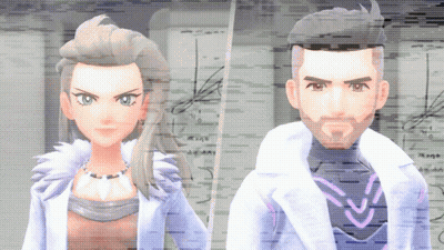 Man and Woman Standing in Front of Computer Screen