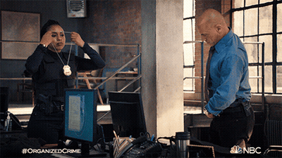 Man And Woman Standing In Front Of Computer With NBC Logo GIF