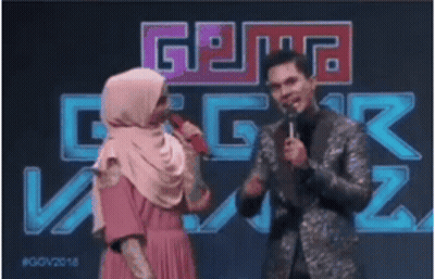 Man And Woman Standing In Front Of Gov Sign GIF
