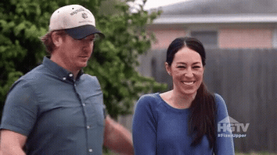 Man And Woman Standing In Front Of HGTV House GIF