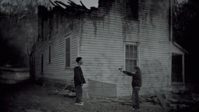 Man And Woman Standing In Front Of House GIF