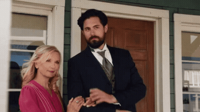 Man And Woman Standing In Front Of House GIF