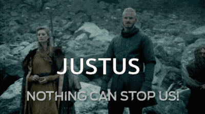Man And Woman Standing In Front Of Justus Sign GIF