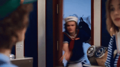 Man And Woman Standing In Front Of Mirror GIF