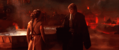 Man And Woman Standing In Front Of Red Fire GIF