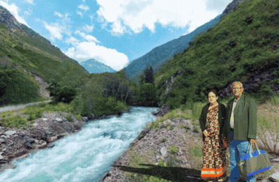 Man And Woman Standing In Front Of River GIF