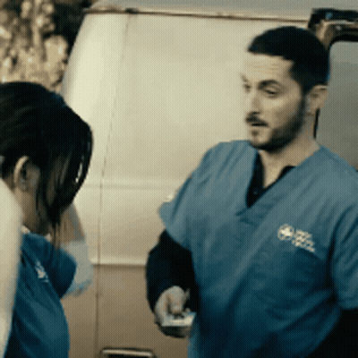 Man And Woman Standing In Front Of Van GIF