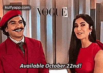 Man And Woman Standing In Front Of Vogue Sign GIF