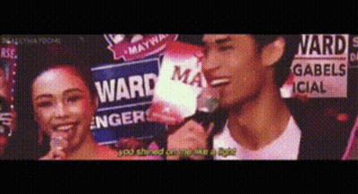 Man And Woman Standing In Front Of Ward Sign GIF