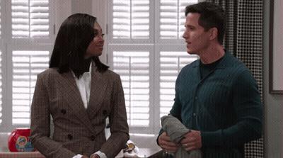 Man And Woman Standing In Front Of Window With Shutters And Tide Laundry Detergent GIF