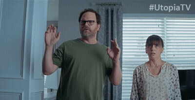 Man And Woman Standing In Front Of Window With Utopiatv GIF