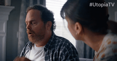 Man And Woman Standing In Front Of Window With Utopiatv GIF