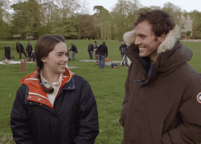 Man And Woman Standing In Grassy Field GIF