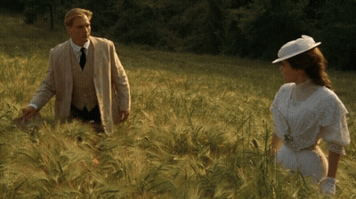 Man And Woman Standing In Tall Grass GIF