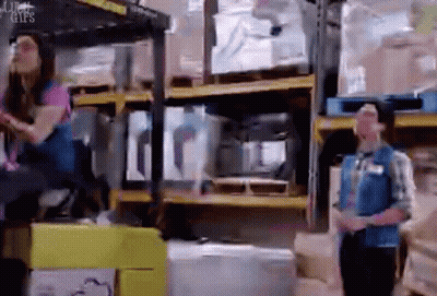 Man And Woman Standing In Warehouse GIF