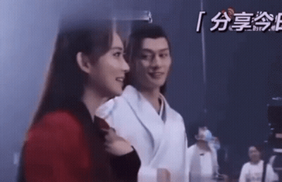Man And Woman Standing Looking At Each Other GIF