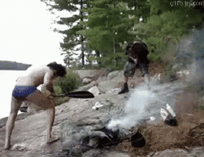 Man And Woman Standing Near Fire GIF