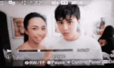 Man And Woman Standing Next To Camera Screen GIF