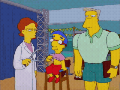 Man And Woman Standing Next To Cartoon Character GIF