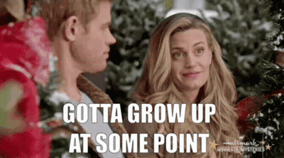 Man And Woman Standing Next To Christmas Tree GIF