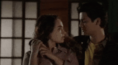Man And Woman Standing Next To Each Other In Room GIF