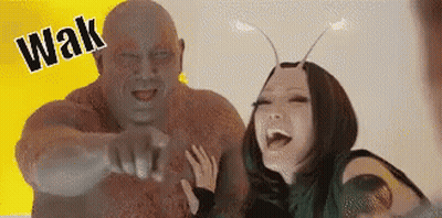 Man And Woman Standing Next To Each Other Laughing GIF