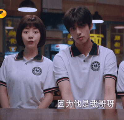 Man And Woman Standing Next To Each Other With Chinese Writing GIF