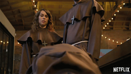 Man And Woman Standing Next To Each Other With Netflix Logo GIF