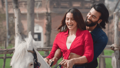 Man And Woman Standing Next To Horse GIF