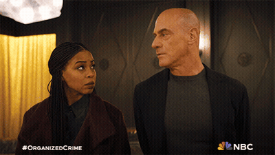 Man And Woman Standing Next To NBC Logo GIF
