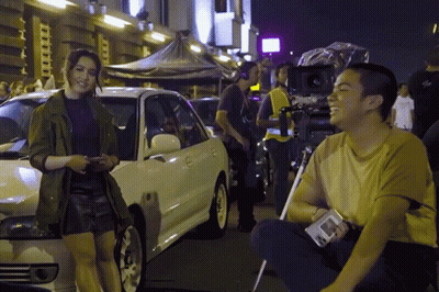 Man And Woman Standing Next To White Car GIF