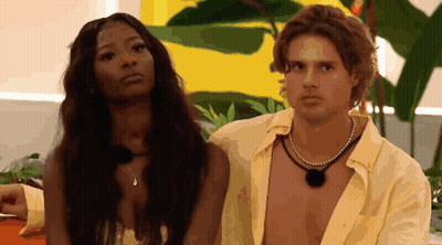 Man And Woman Standing Next To Yellow Wall GIF