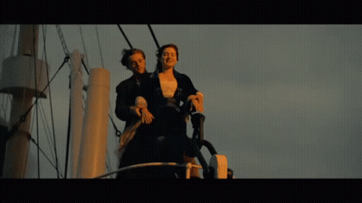 Man And Woman Standing On A Boat GIF