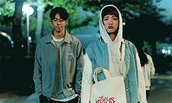 Man And Woman Standing On Sidewalk GIF