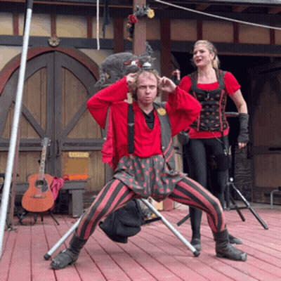 Man And Woman Standing On Stage With Catering Sign GIF