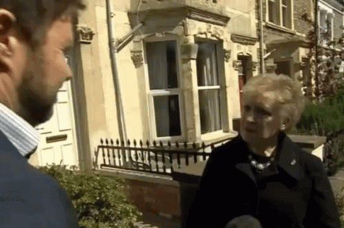 Man And Woman Standing Outside House GIF