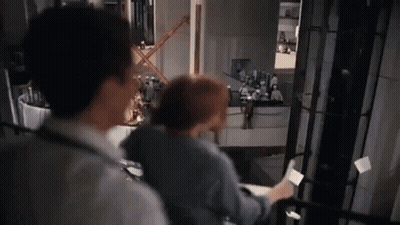 Man And Woman Standing Together In Kitchen GIF