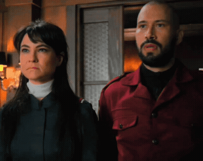 Man And Woman Standing Together Looking At Something GIF