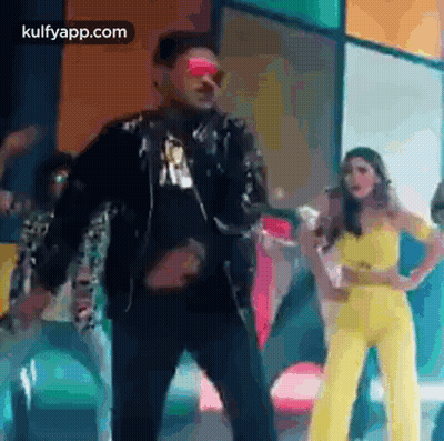 Man And Woman Standing Together On Stage GIF