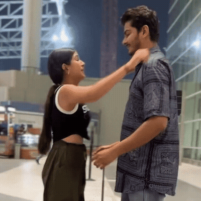 Man And Woman Standing Together With Hand On Neck GIF