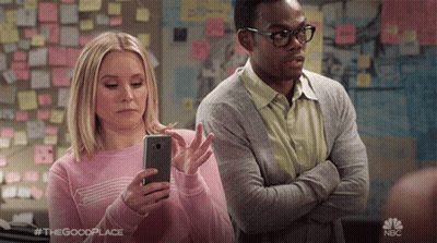 Man and Woman Standing Together Woman Looking at Phone