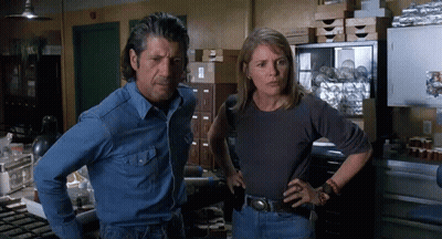 Man And Woman Standing With Hands On Hips GIF
