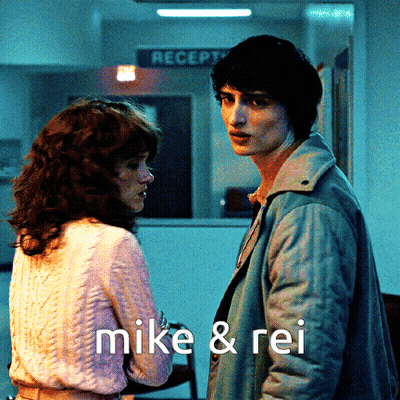 Man And Woman Standing With Mike & Rei GIF