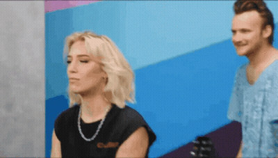 Man And Woman Standing, Woman In Black Shirt Saying Culture GIF