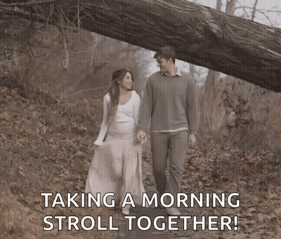 Man And Woman Taking Morning Stroll In Woods GIF