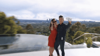 Man And Woman Taking Selfie With Netflix Logo GIF